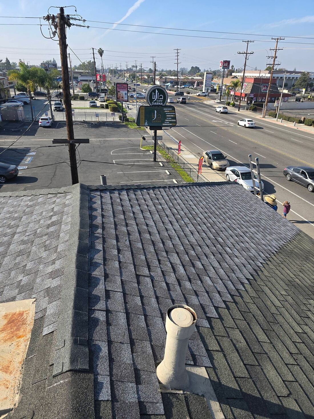 Commercial shingle roof replacement above a storefront in Orange County